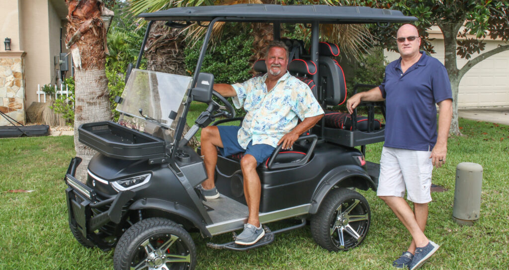 Photo of owners on golf cart